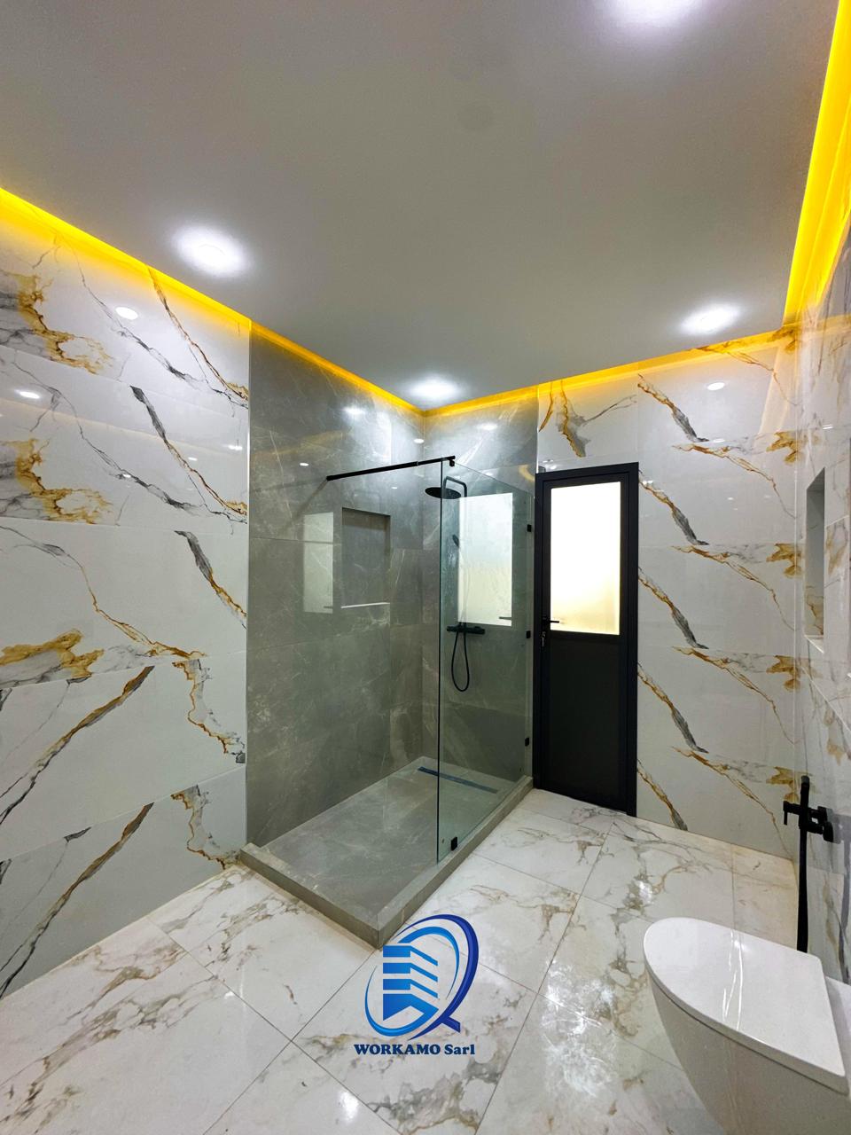 Salle de bain en marbre avec douche à l'italienne